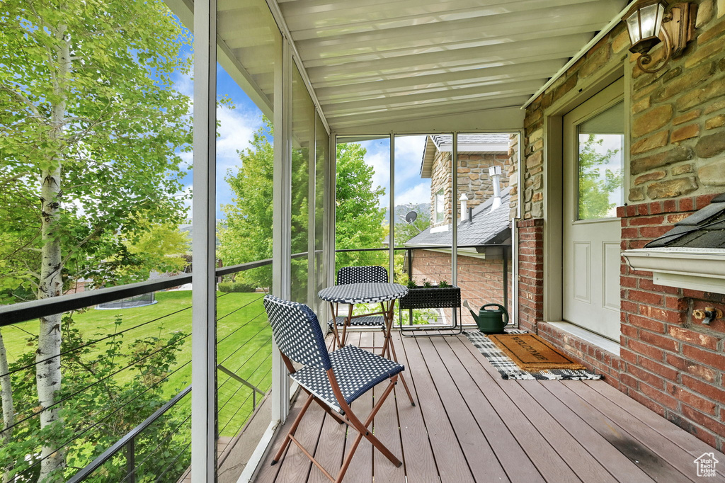 Sunroom featuring vaulted ceiling