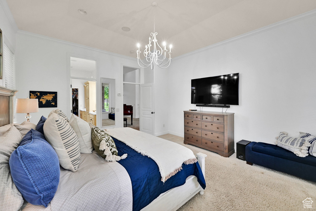 Carpeted bedroom featuring a chandelier and crown molding