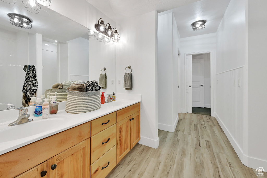 Bathroom with wood finished floors and double vanity