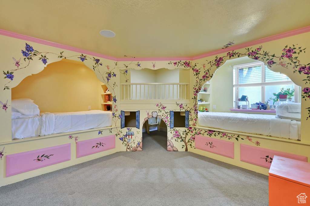Carpeted bedroom featuring crown molding
