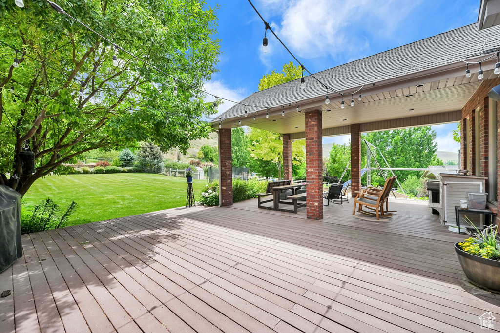 Wooden deck featuring a yard