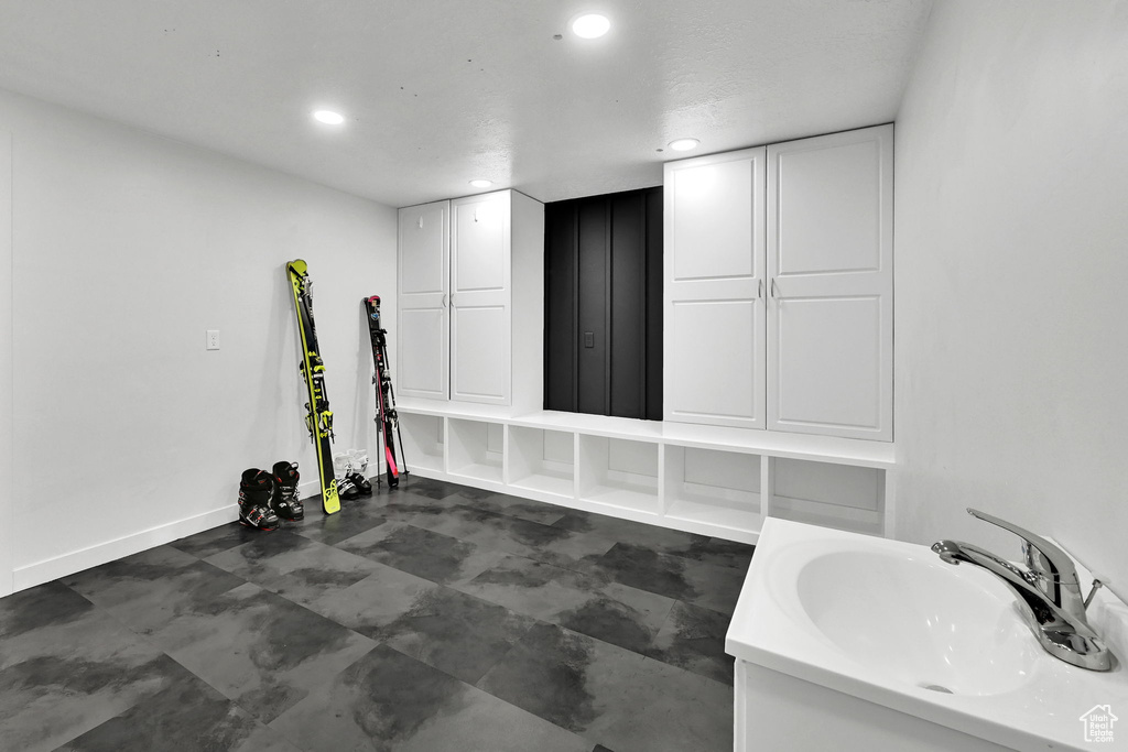 Workout area with a sink and recessed lighting