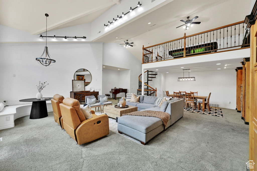 Carpeted living area with a ceiling fan, stairs, high vaulted ceiling, and recessed lighting