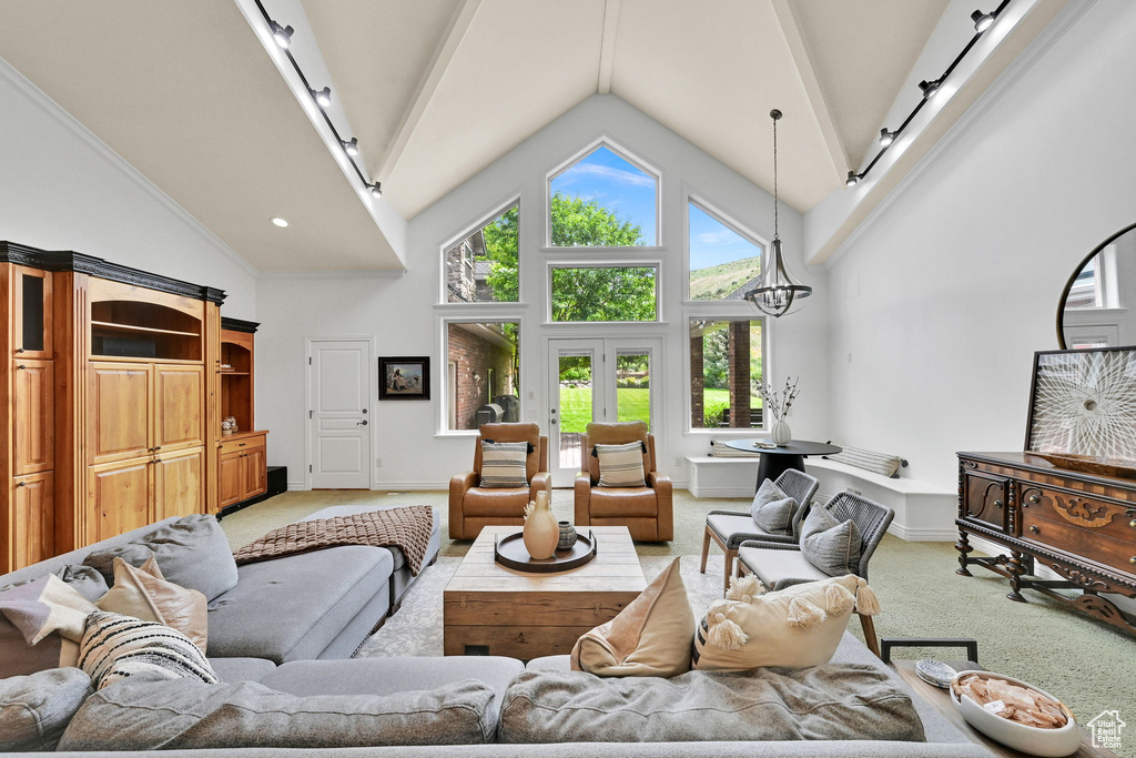 Living area featuring light colored carpet and high vaulted ceiling