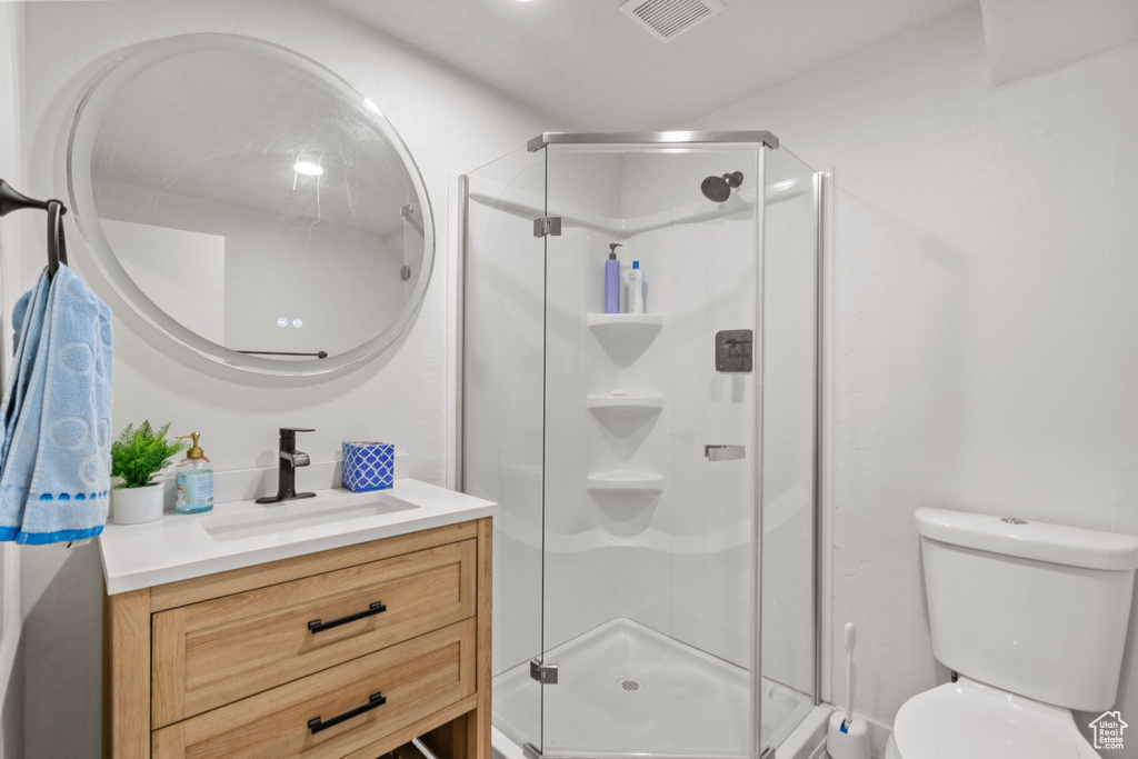 Bathroom with vanity and a stall shower