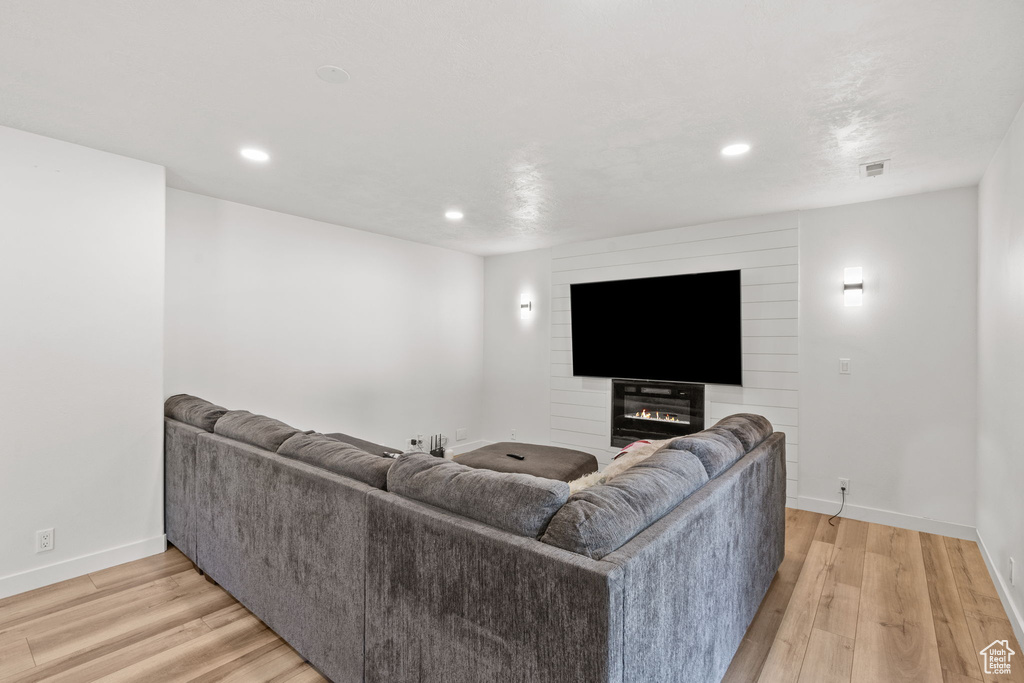 Living room featuring light wood-style flooring and recessed lighting