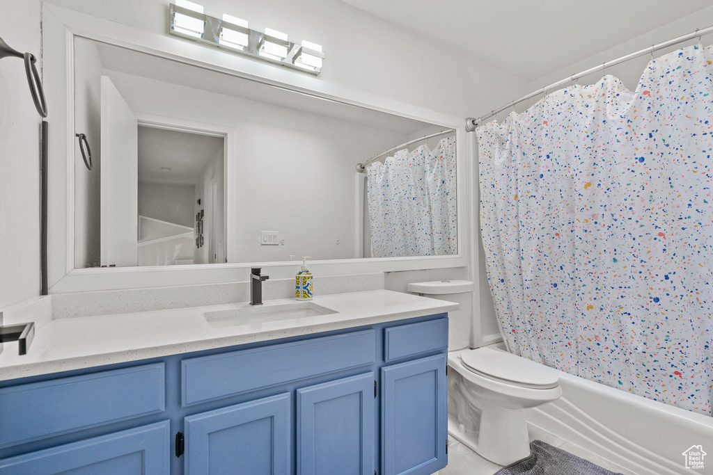 Full bathroom with vanity and shower / bath combo with shower curtain