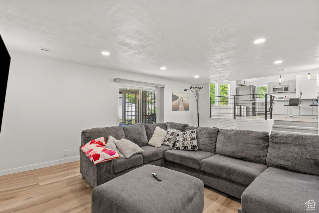 Living room featuring light wood finished floors and recessed lighting