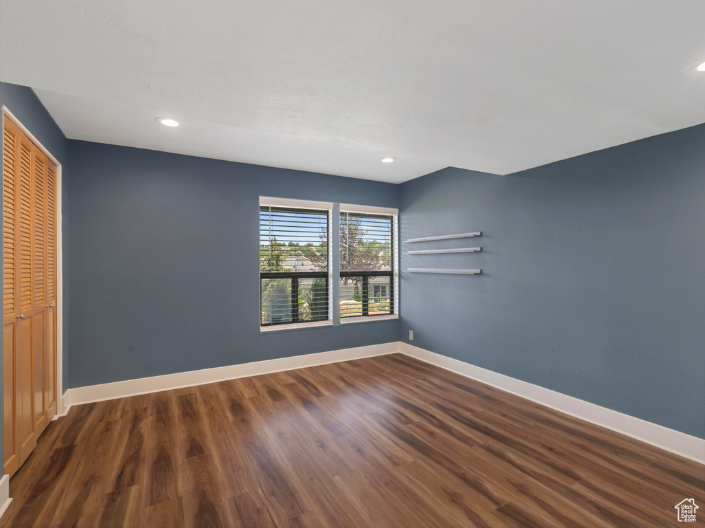 Unfurnished bedroom with a closet, wood finished floors, and recessed lighting