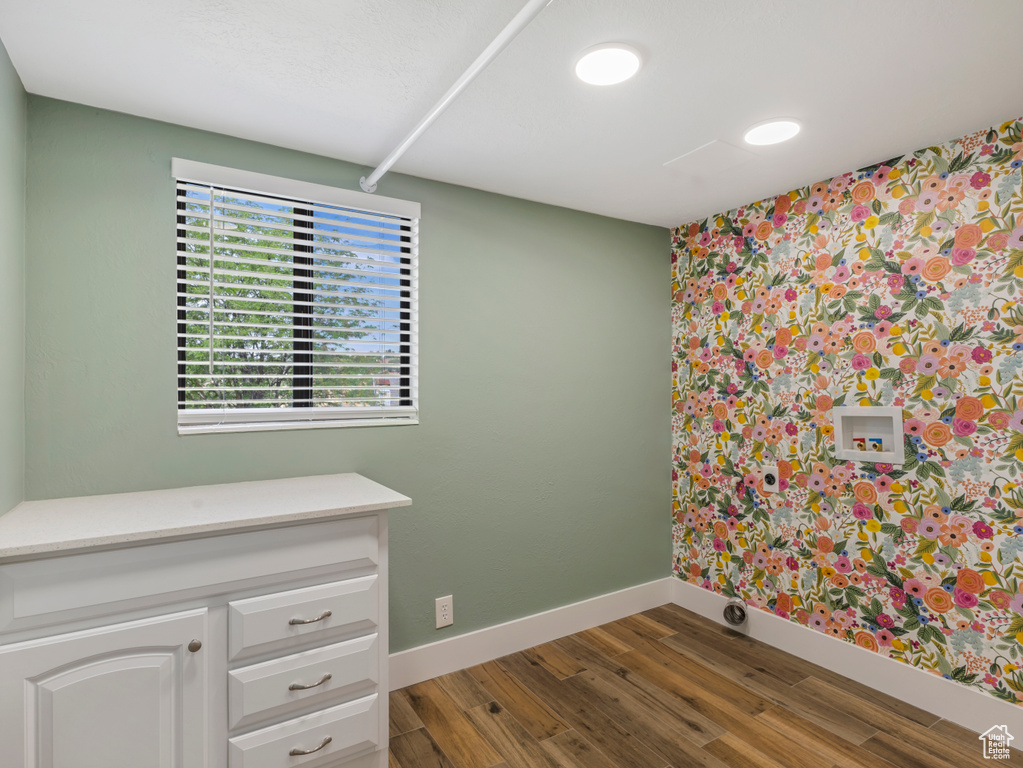 Unfurnished room with baseboards and wood finished floors