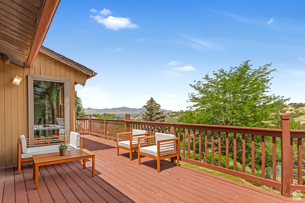 Deck featuring a mountain view and outdoor lounge area