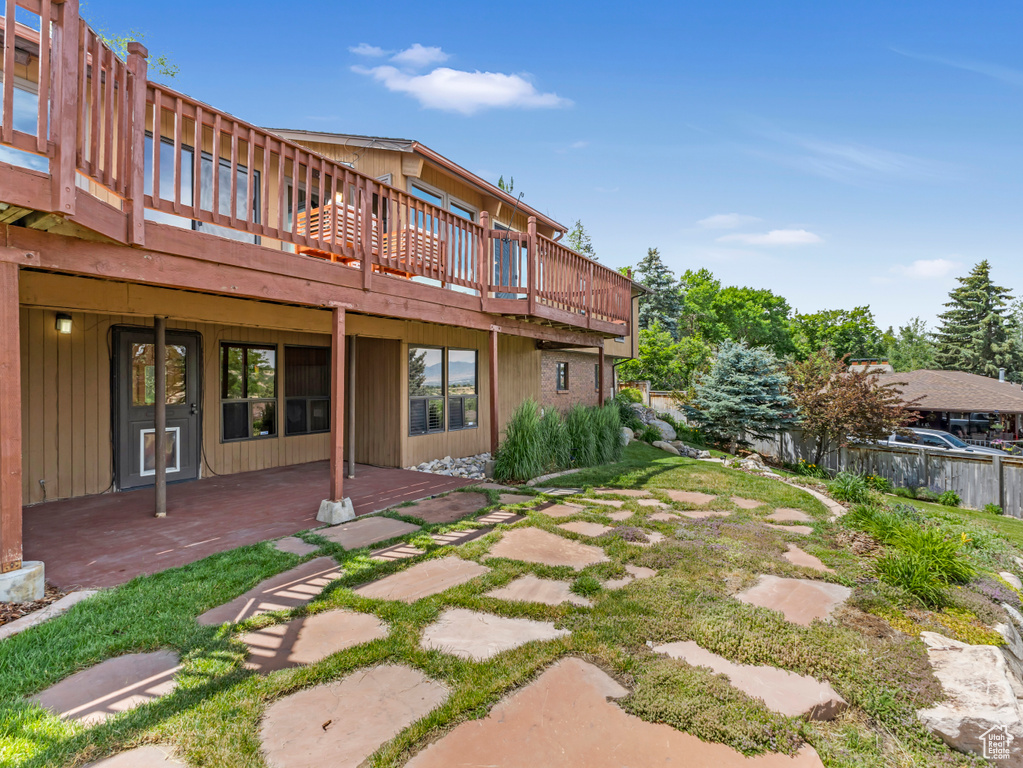 Back of house featuring a deck and a patio