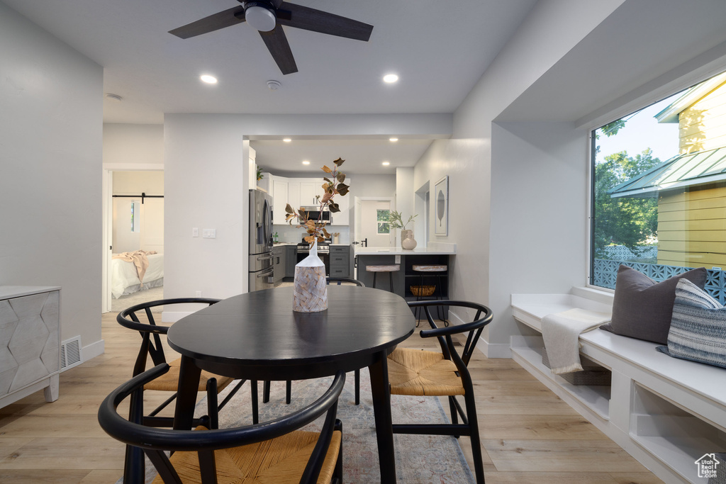 Dining area featuring a ceiling fan, light wood-style floors, and recessed lighting