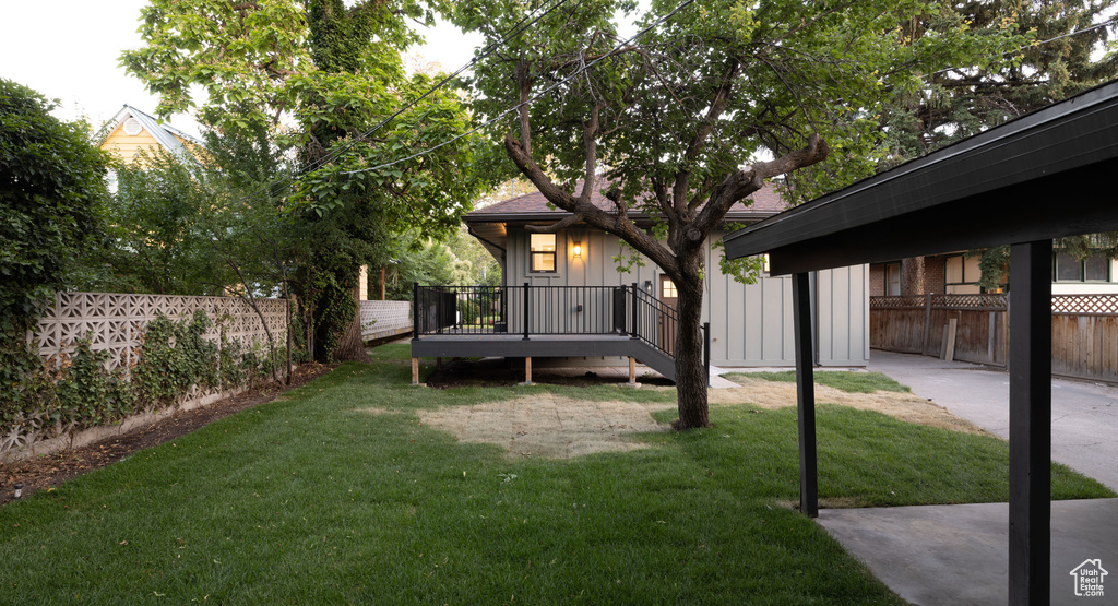Rear view of house featuring a fenced backyard and board and batten siding