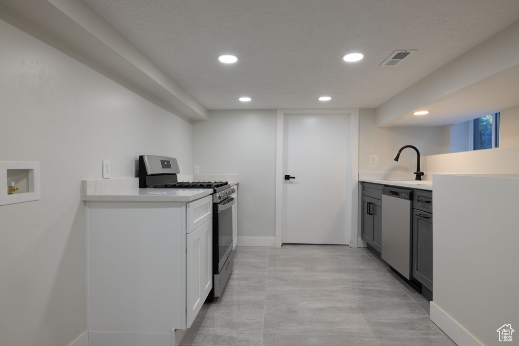 Kitchen with stainless steel appliances, recessed lighting, and light countertops