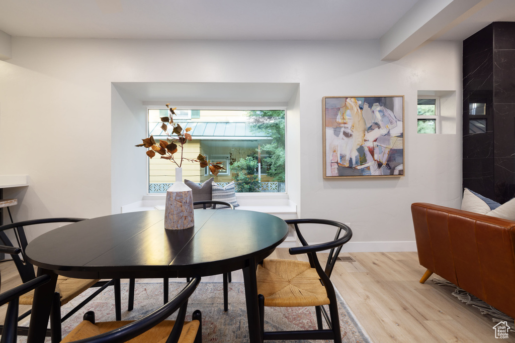 Dining space with light wood-style floors and baseboards