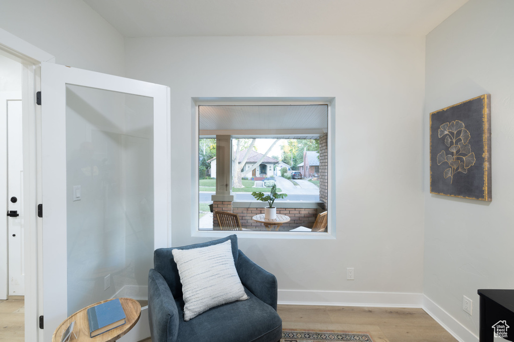 Sitting room with wood finished floors and baseboards