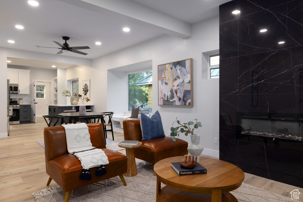 Living area featuring light wood finished floors, recessed lighting, healthy amount of natural light, and ceiling fan