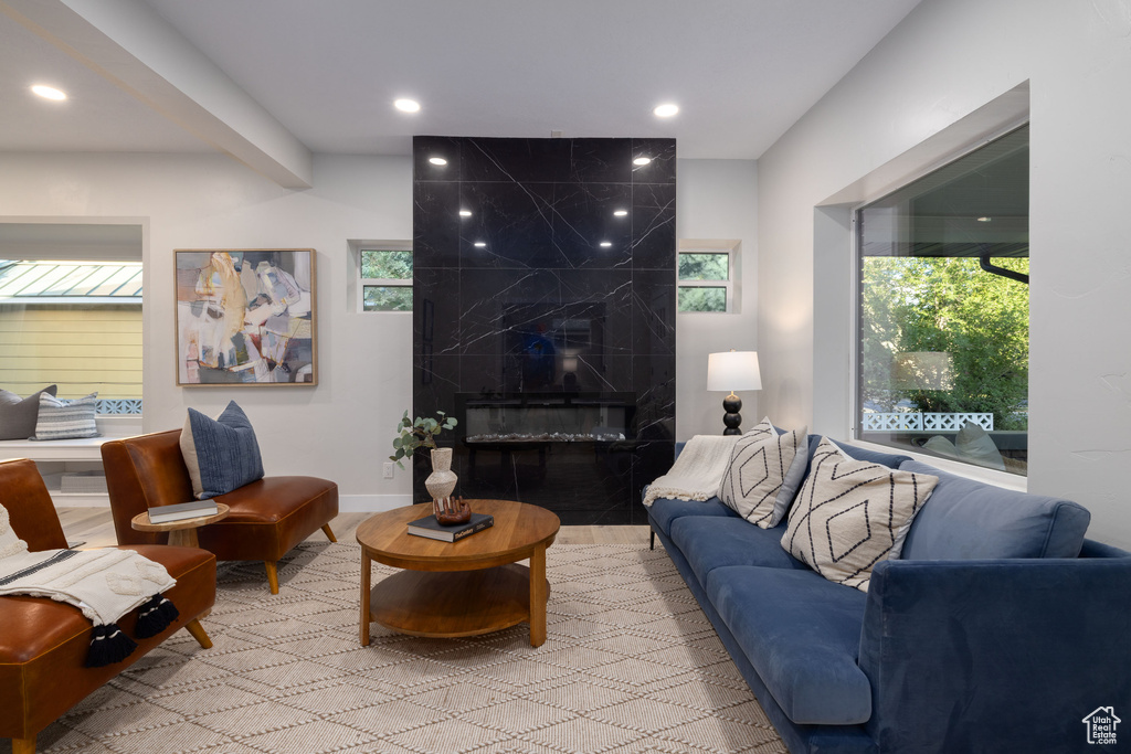 Living area with recessed lighting, a fireplace, and wood finished floors