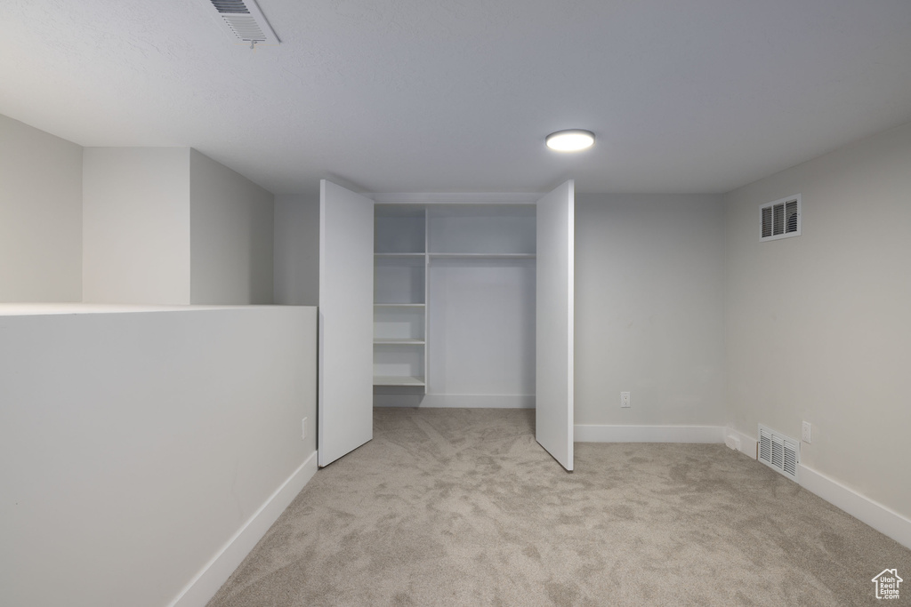 Unfurnished bedroom featuring carpet flooring and a closet