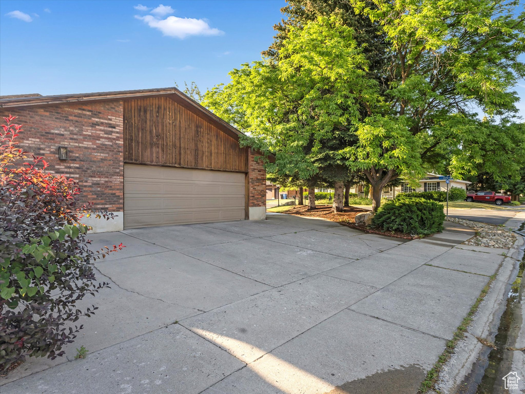 Garage featuring concrete driveway