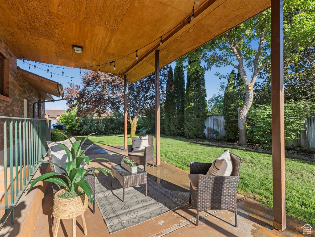 Fenced backyard with a patio area and outdoor lounge area