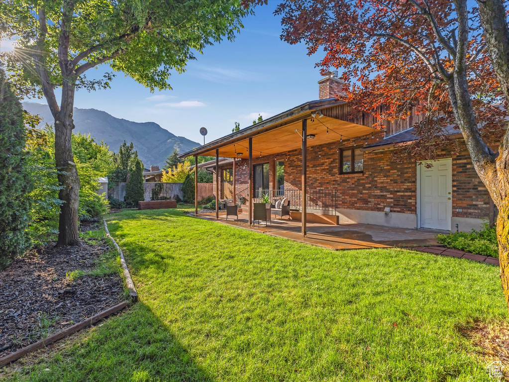 View of yard featuring a patio area and a mountain view