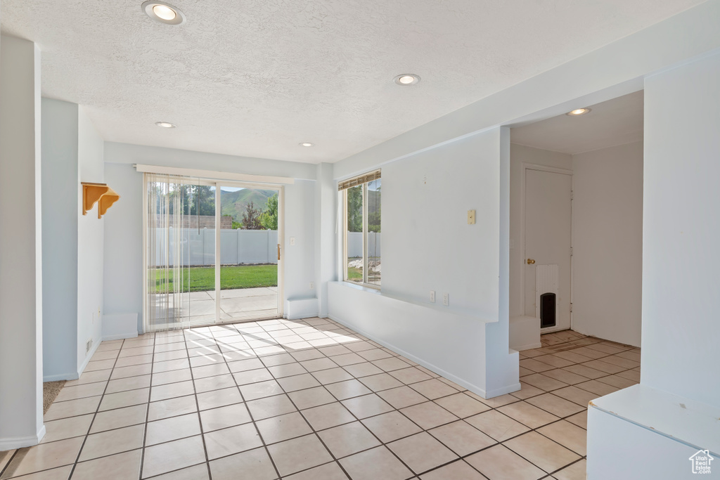 Spare room featuring recessed lighting, light tile patterned flooring, and a textured ceiling