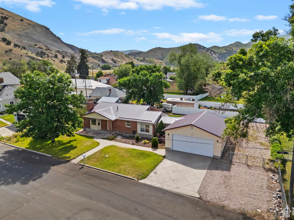 Aerial view of residential area featuring a mountainous background