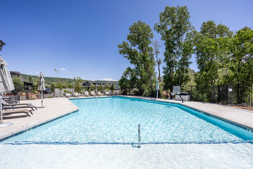 Community pool featuring a patio