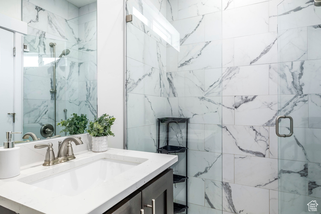 Full bathroom with vanity and a shower stall