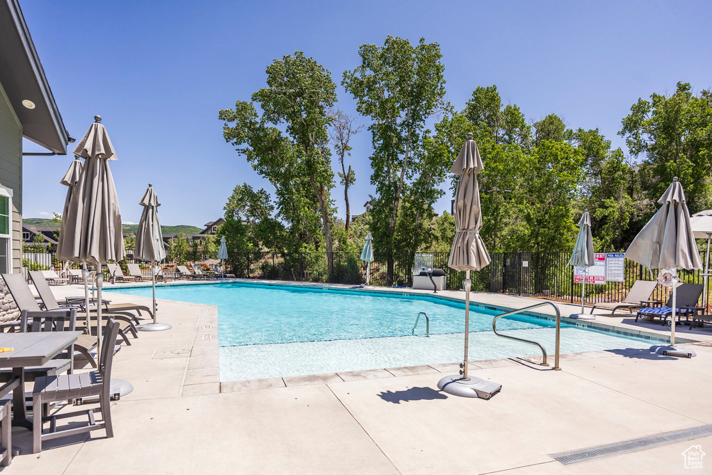 Community pool featuring a patio