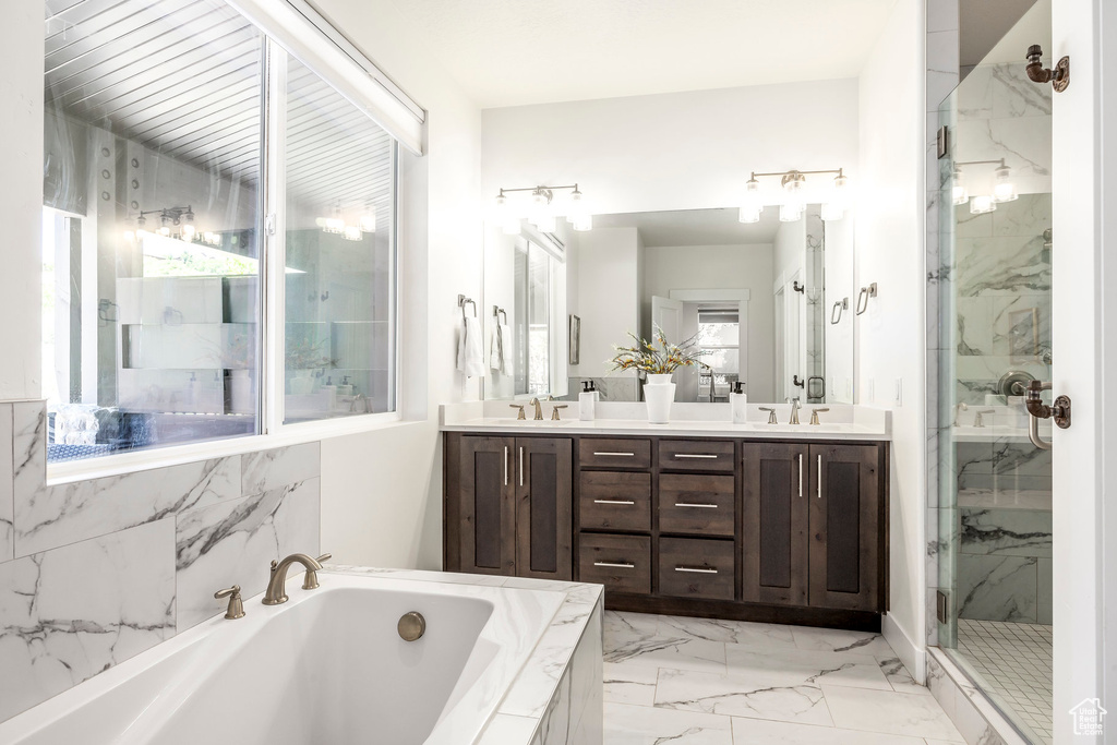 Bathroom with a marble finish shower, a garden tub, marble finish floors, and double vanity