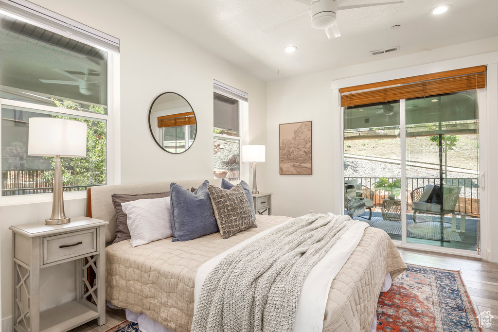 Bedroom with access to exterior, wood finished floors, recessed lighting, and ceiling fan