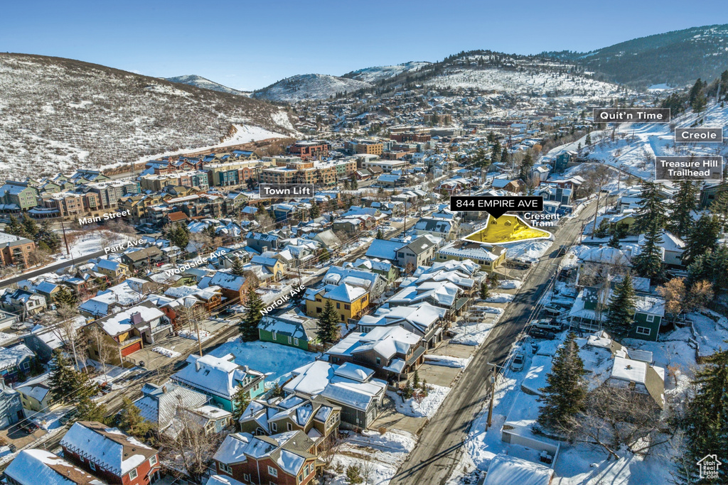 Snowy aerial view with a mountain view and a residential view