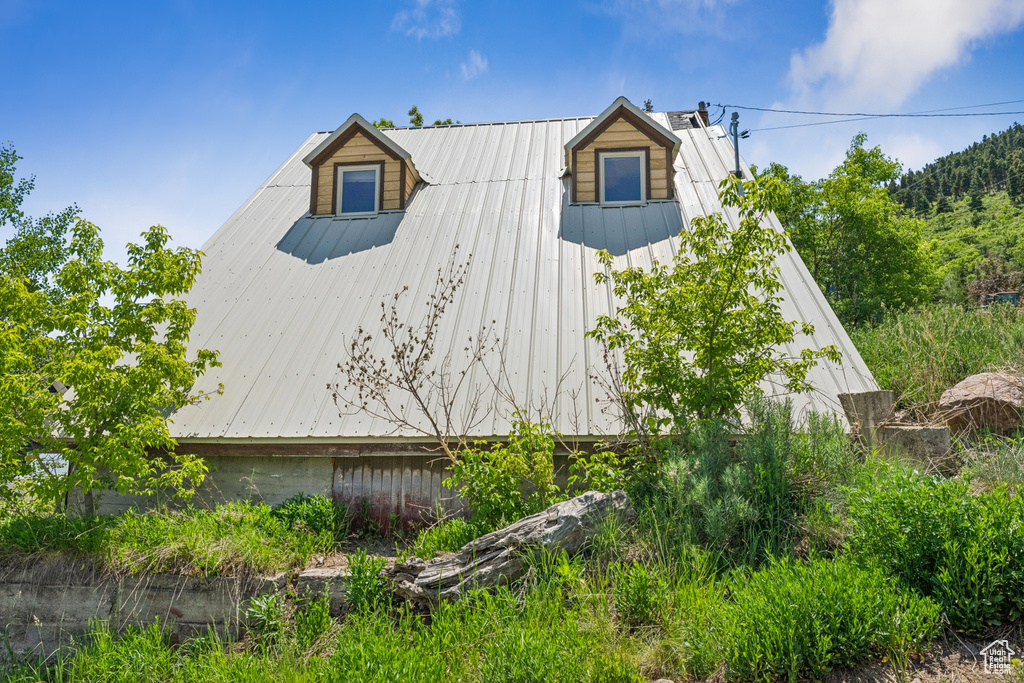View of side of home with a metal roof