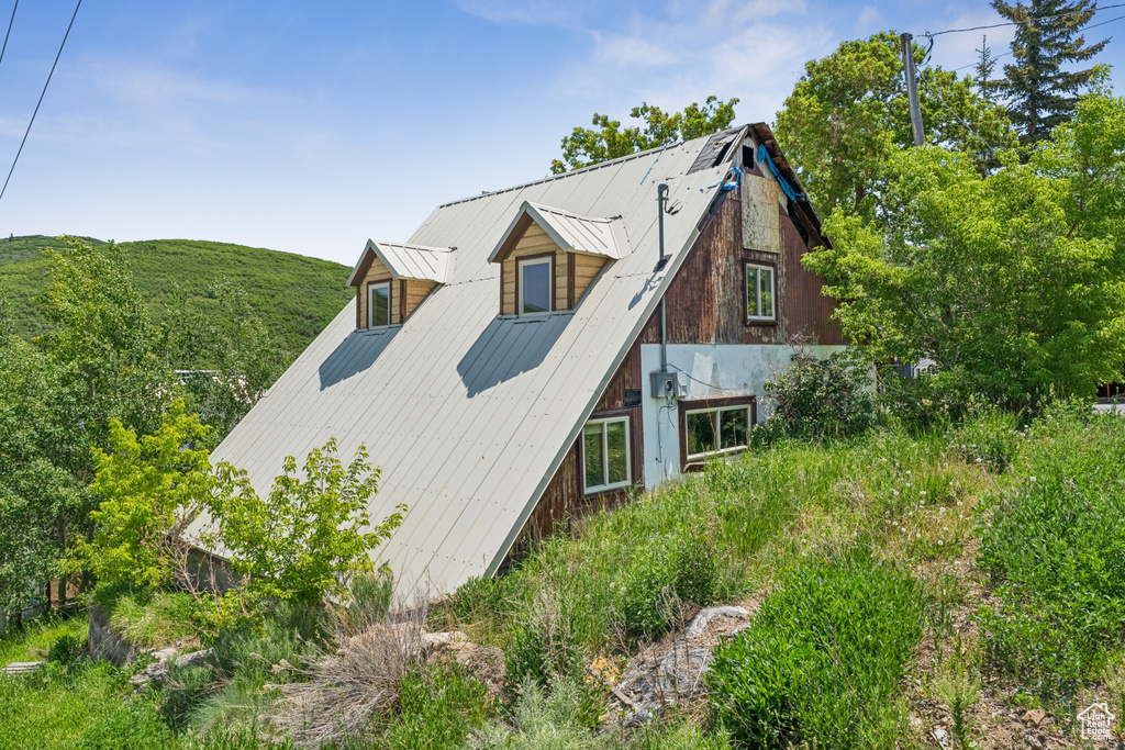 View of side of property featuring a metal roof