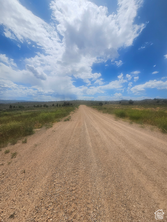 View of dirt / gravel road with a view of countryside