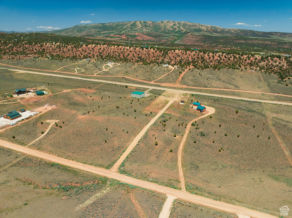 Aerial view of property\'s location featuring rural landscape and a mountainous background