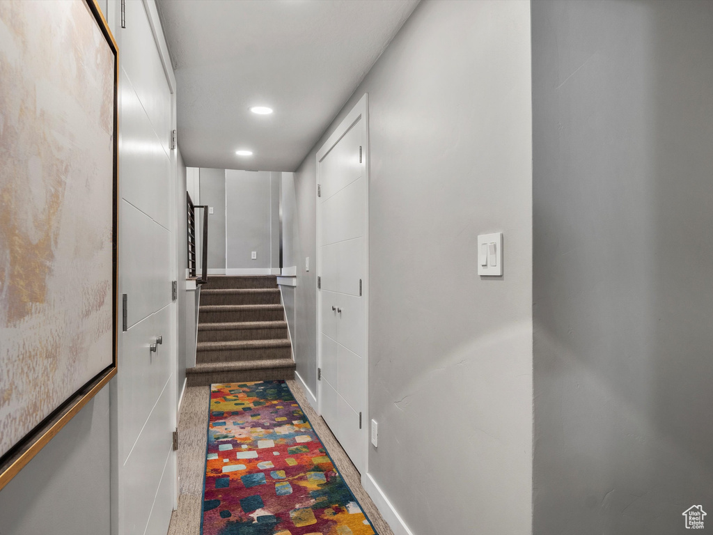 Corridor featuring stairway and recessed lighting