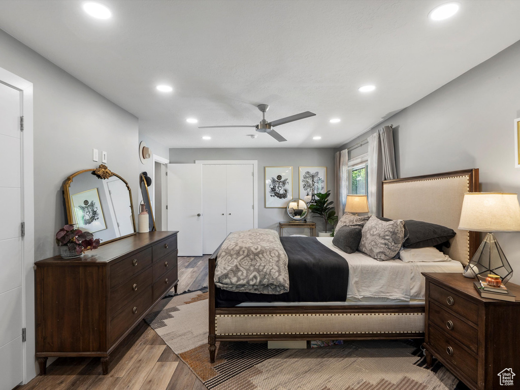 Bedroom featuring wood finished floors, recessed lighting, ceiling fan, and a closet