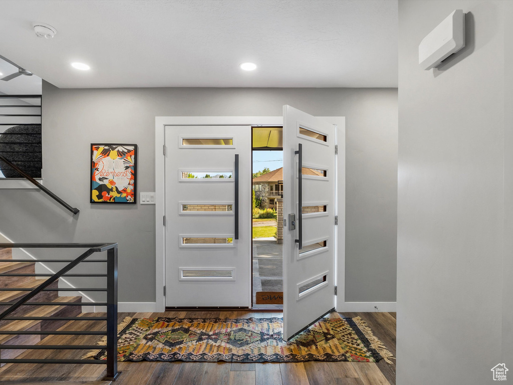Entrance foyer featuring dark wood-style flooring and recessed lighting