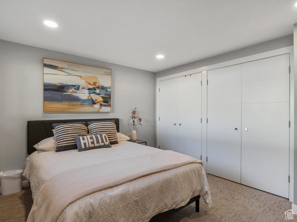 Carpeted bedroom with recessed lighting
