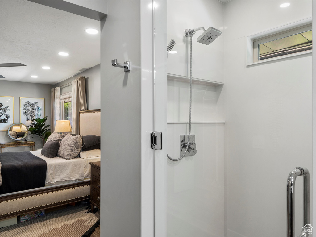 Ensuite bathroom featuring recessed lighting, a shower, and ceiling fan