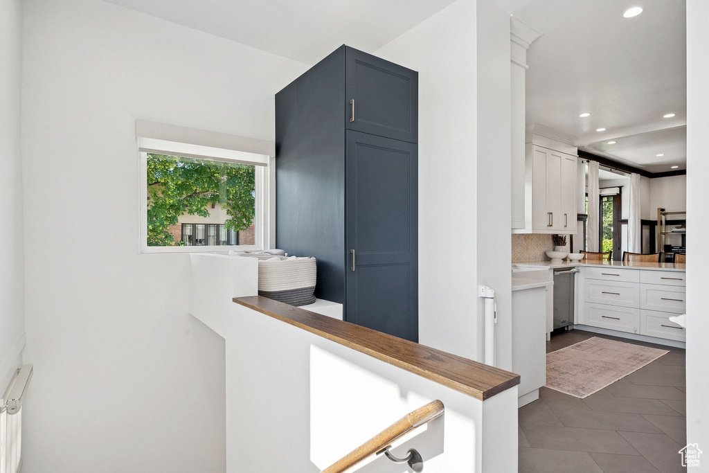 Kitchen with backsplash, recessed lighting, dark tile patterned floors, dishwasher, and light countertops