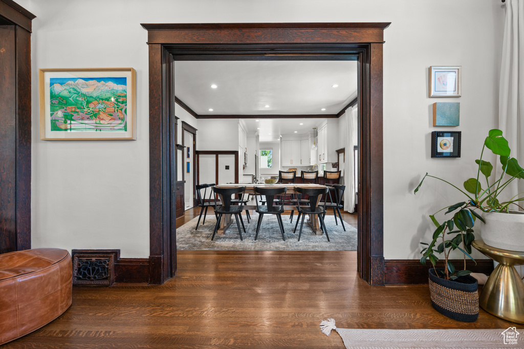 Dining area featuring wood finished floors and ornamental molding