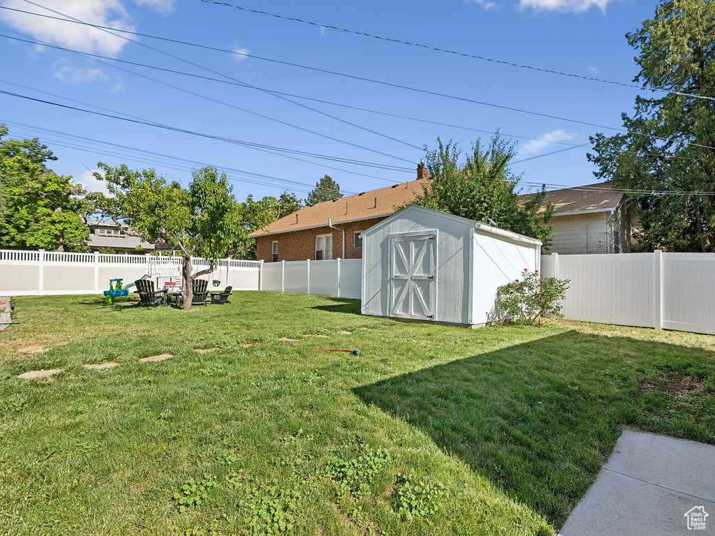 Fenced backyard with a storage shed