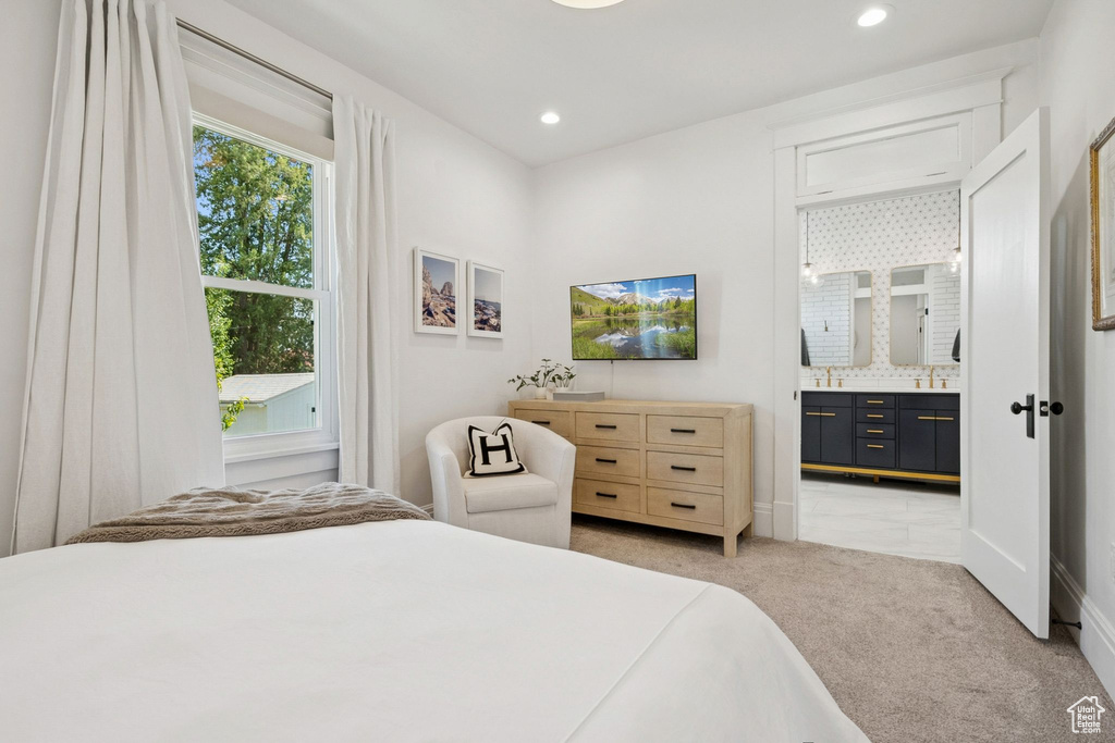 Bedroom with light carpet, ensuite bath, and recessed lighting