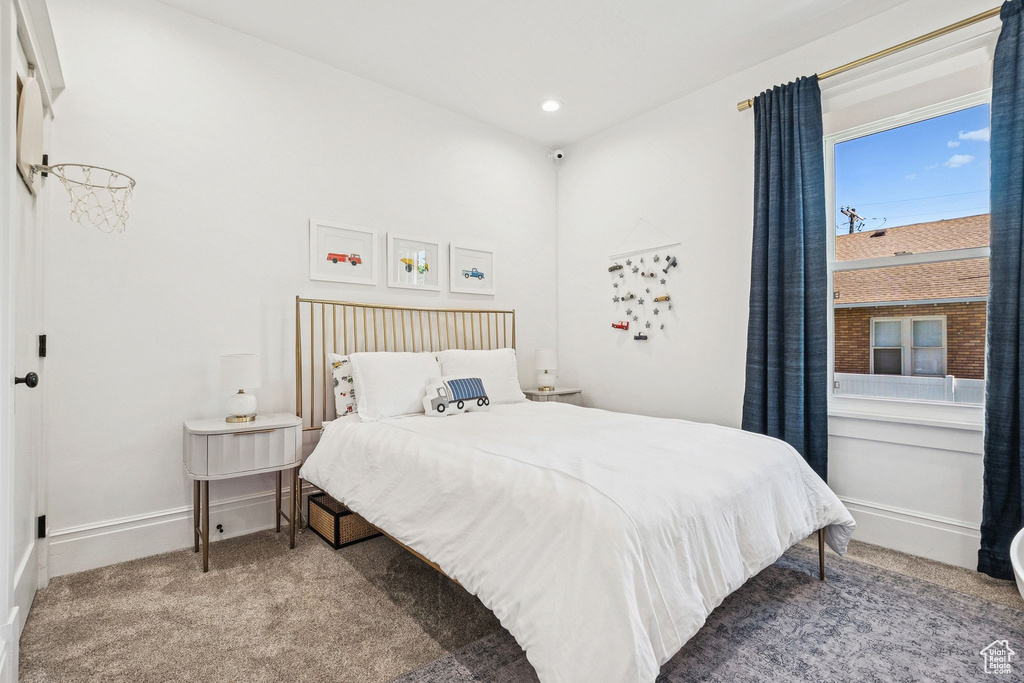 Carpeted bedroom with baseboards and recessed lighting