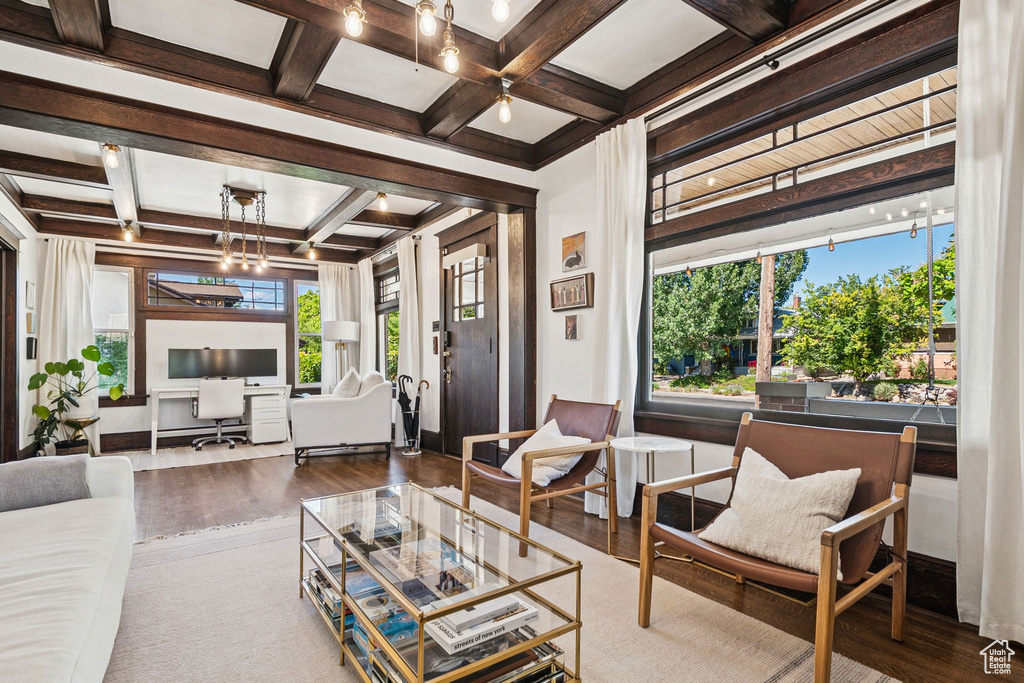 Living area with wood finished floors, coffered ceiling, and beamed ceiling